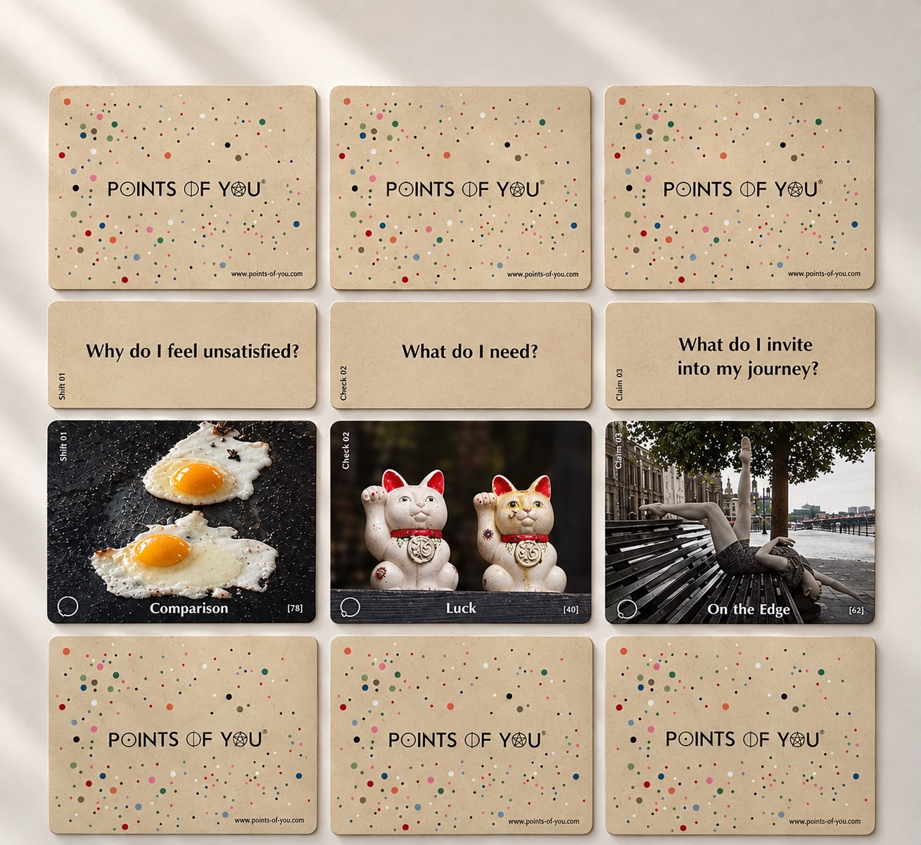 A spread of Points of You® cards — photo cards like Comparison, Luck and On the Edge beside their question cards, laid out on a warm surface
